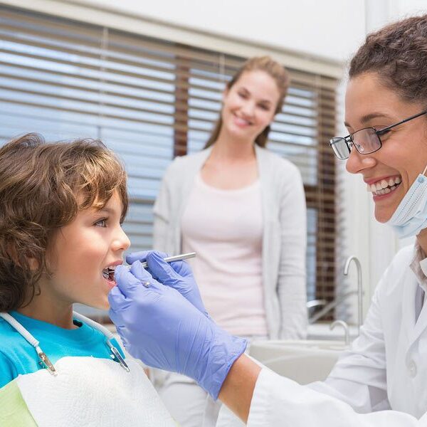 Dentist examining the teeth of a kid