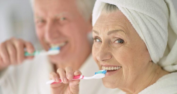 Senior couple with toothbrushes