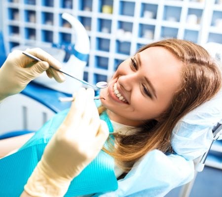 Women smiling before the dentist performs the dental procedure