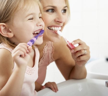 Mother and Daughter Brushing Teeth Together